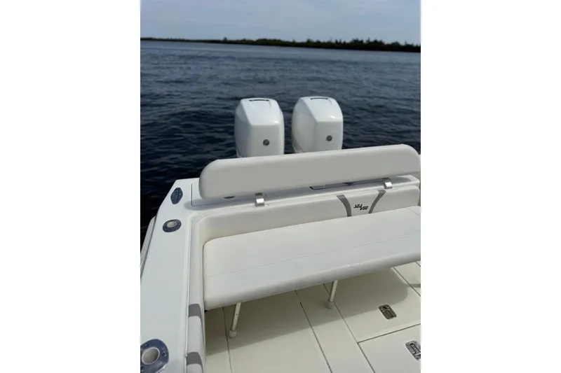 Slide: The Image of 2014 SeaVee 290B boat with dual engines on calm water. - 8