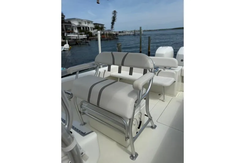 Slide: The Image of 2014 SeaVee 290B boat interior with cushioned seating and ocean view. - 9
