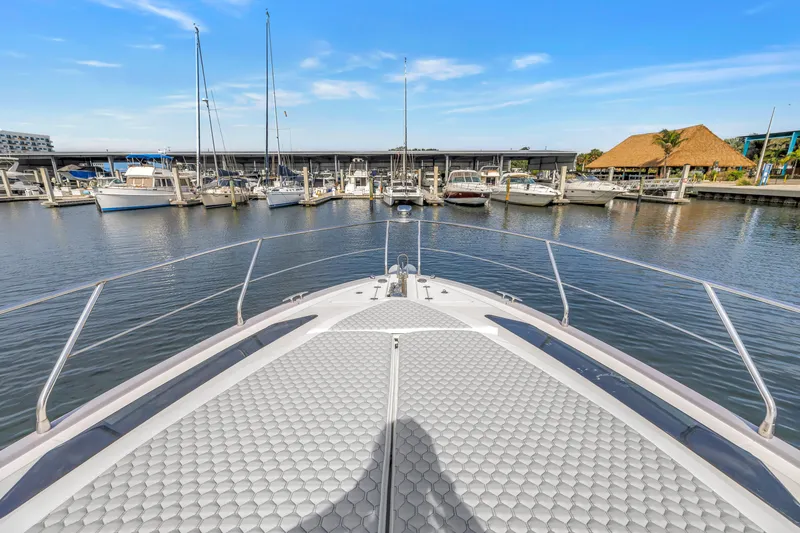Slide: The Image of Bow view of 2009 Marquis 500 Sport Bridge yacht docked at marina. - 10