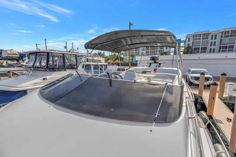 Slide: The Image of 2009 Marquis 500 Sport Bridge yacht docked at marina under clear blue sky. - 11