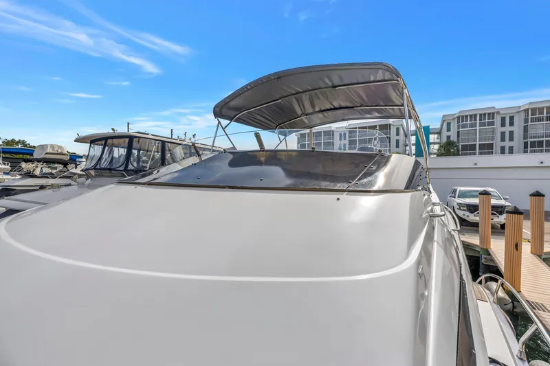 Slide: The Image of 2009 Marquis 500 Sport Bridge yacht docked, showcasing sleek design and modern features. - 12