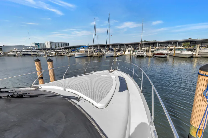 Slide: The Image of 2009 Marquis 500 Sport Bridge yacht docked in a marina under clear blue skies. - 13