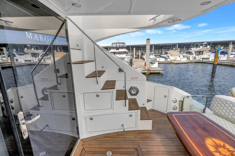 Slide: The Image of Luxury yacht Marquis 500 Sport Bridge 2009, featuring elegant deck and marina view. - 20