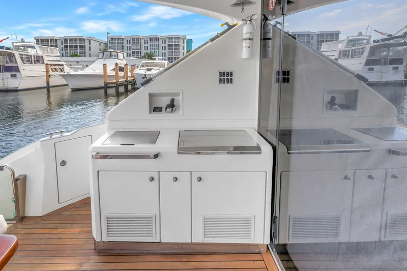 Slide: The Image of Outdoor kitchen on 2009 Marquis 500 Sport Bridge yacht, docked with other boats. - 21