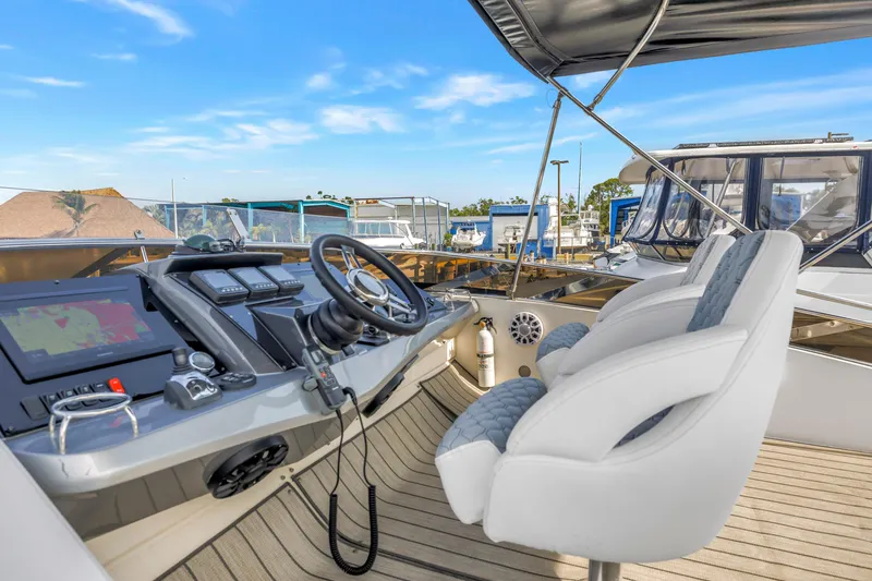 Slide: The Image of Helm of 2009 Marquis 500 Sport Bridge yacht with modern controls and plush seating. - 24