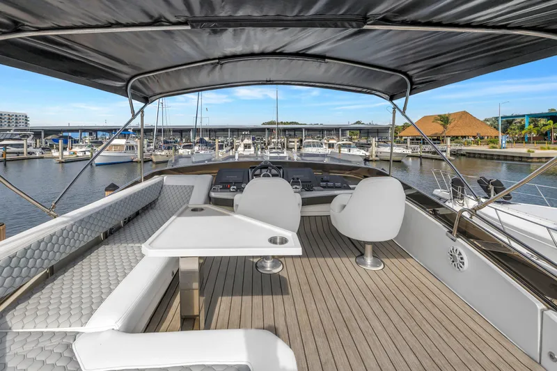 Slide: The Image of Luxurious 2009 Marquis 500 Sport Bridge yacht interior with elegant seating and helm at marina. - 30
