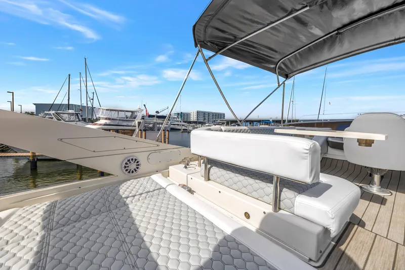 Slide: The Image of Luxury 2009 Marquis 500 Sport Bridge yacht interior with white seating and marina view. - 33