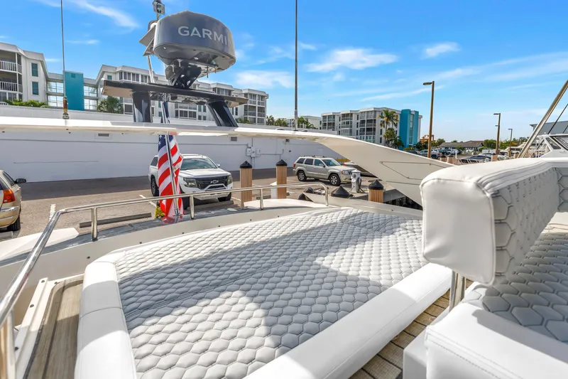 Slide: The Image of 2009 Marquis 500 Sport Bridge yacht with sun deck and American flag in marina. - 35
