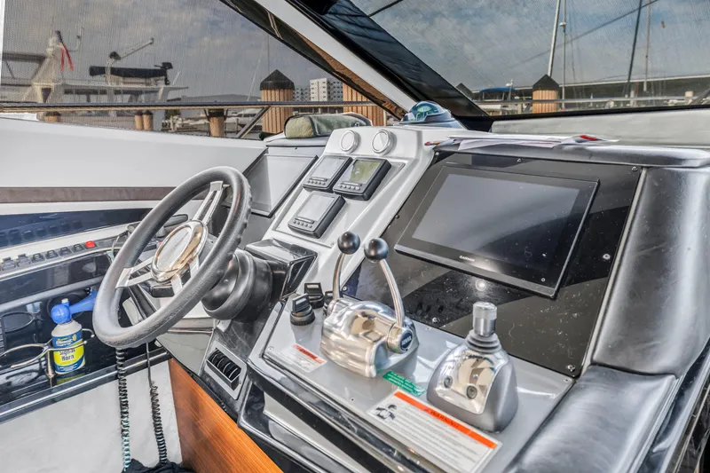 Slide: The Image of Control panel of a 2009 Marquis 500 Sport Bridge yacht, featuring advanced navigation systems. - 40