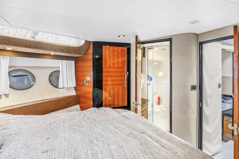 Slide: The Image of Luxurious 2009 Marquis 500 Sport Bridge yacht interior with cozy bedroom and modern bathroom. - 52