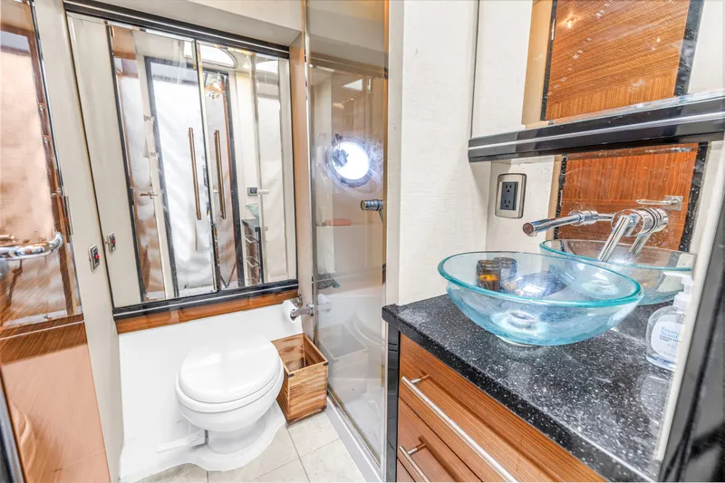 Slide: The Image of Luxurious 2009 Marquis 500 Sport Bridge yacht bathroom with glass sink and modern fixtures. - 54