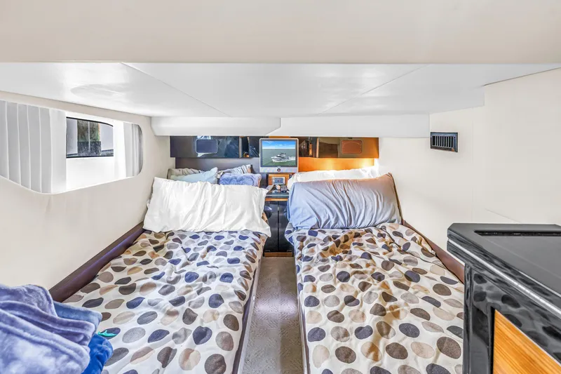 Slide: The Image of 2009 Marquis 500 Sport Bridge cabin with twin beds and modern decor. - 57