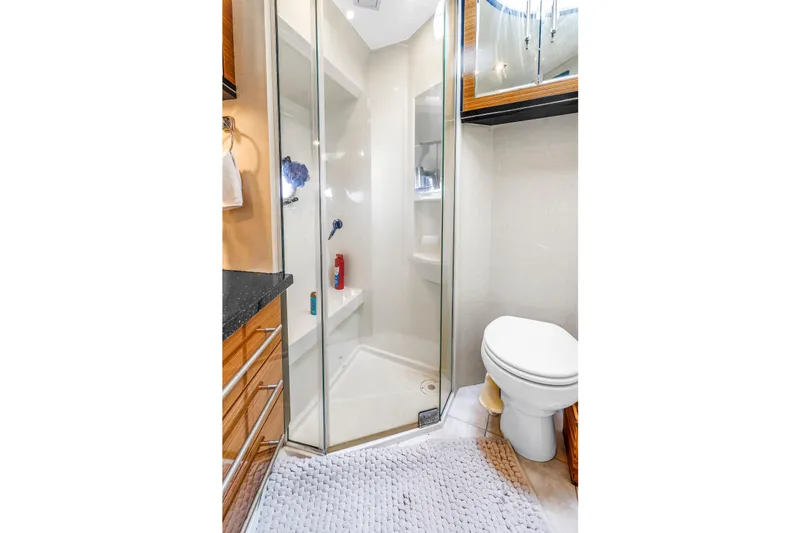Slide: The Image of Bathroom interior of 2009 Marquis 500 Sport Bridge yacht, featuring shower and toilet. - 58