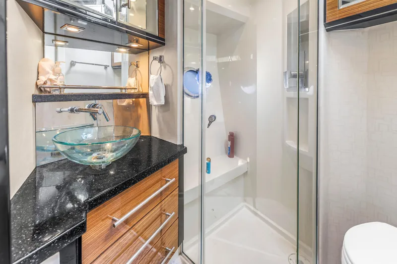 Slide: The Image of Luxurious 2009 Marquis 500 Sport Bridge yacht bathroom with glass sink and modern shower. - 59