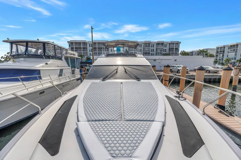 Slide: The Image of 2009 Marquis 500 Sport Bridge yacht docked at marina, clear sky background. - 7
