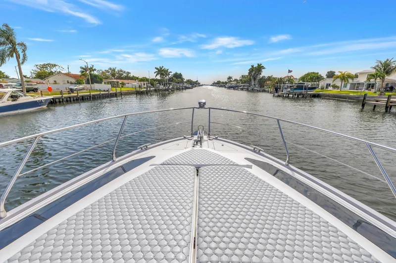Slide: The Image of Bow view of 2009 Marquis 500 Sport Bridge yacht cruising through a scenic canal. - 8