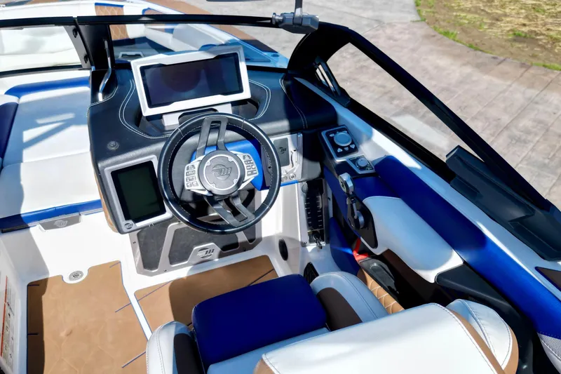 Slide: The Image of 2022 Malibu M240 boat cockpit with modern steering and digital displays. - 11