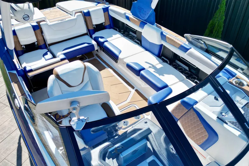 Slide: The Image of 2022 Malibu M240 boat interior with luxurious blue and white seating and modern design. - 13