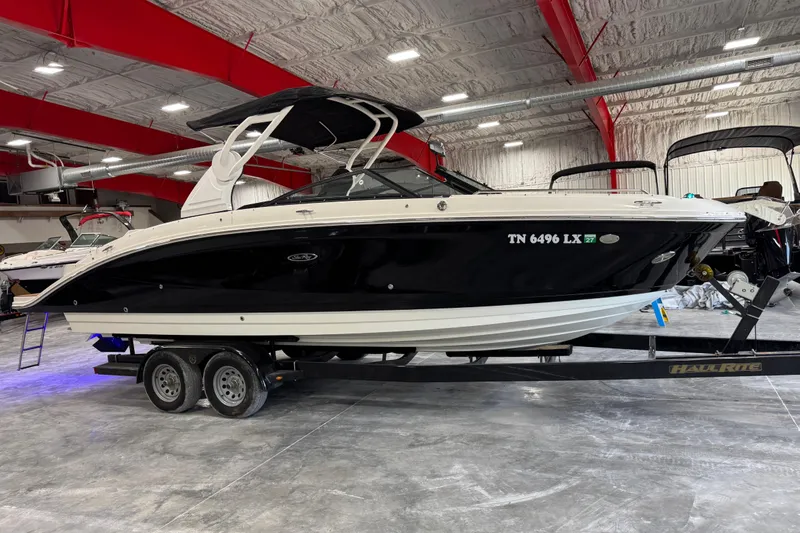 The Image of 2018 Sea Ray SDX 270 boat on trailer in indoor showroom. - 1