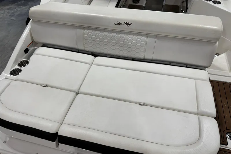 Slide: The Image of 2018 Sea Ray SDX 270 boat with white cushioned seating and cup holders. - 11