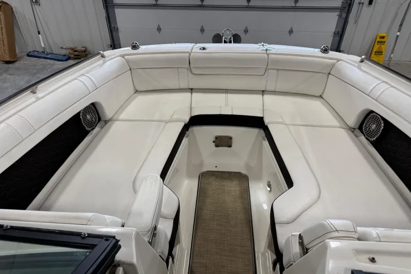Slide: The Image of 2018 Sea Ray SDX 270 boat interior with white seating and speakers. - 13
