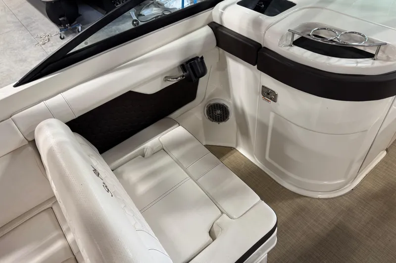 Slide: The Image of Interior of 2018 Sea Ray SDX 270 boat with white seating and cup holders. - 14
