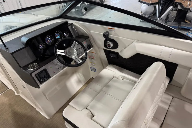 Slide: The Image of 2018 Sea Ray SDX 270 boat interior with steering wheel and dashboard controls. - 15