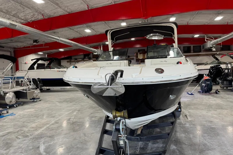 Slide: The Image of 2018 Sea Ray SDX 270 boat displayed in a showroom with red ceiling beams. - 5