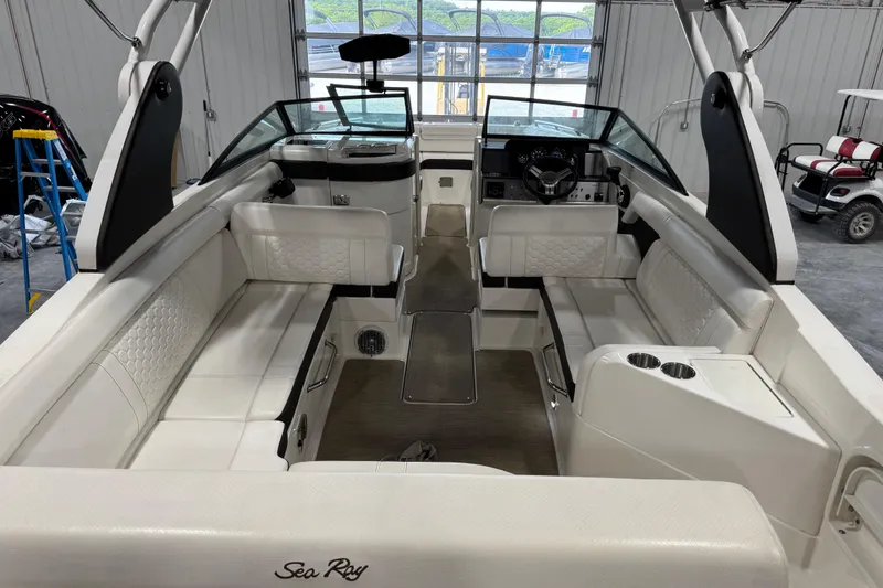 Slide: The Image of 2018 Sea Ray SDX 270 boat interior with white seating and modern dashboard. - 8