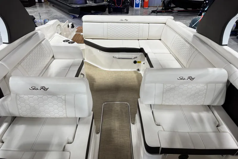 Slide: The Image of Interior of a 2018 Sea Ray SDX 270 boat with white seating and elegant design. - 9