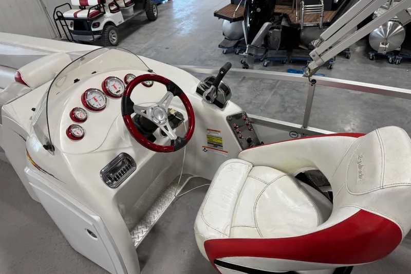 Slide: The Image of Cockpit of 2010 Manitou 25 X-Plode boat with steering wheel and gauges. - 10