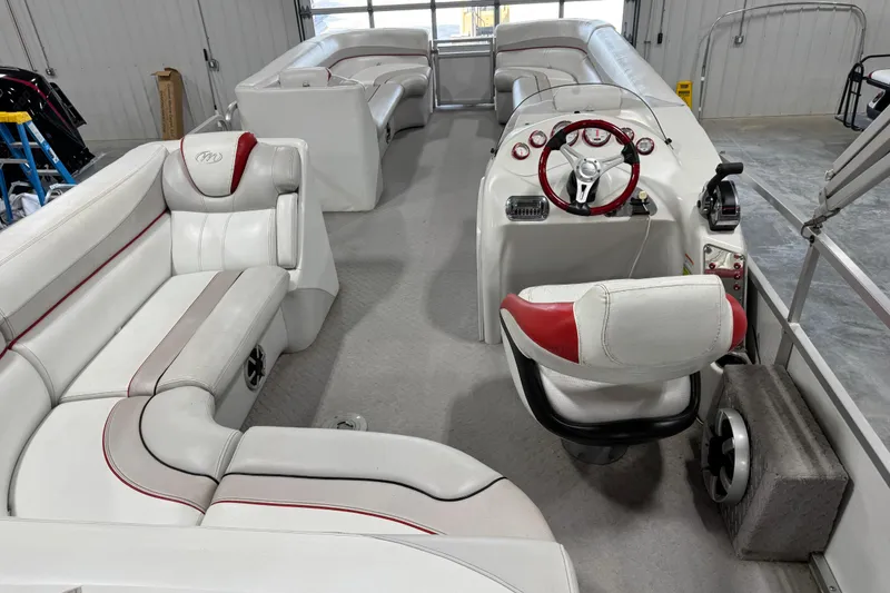 Slide: The Image of Interior of a 2010 Manitou 25 X-Plode pontoon boat with white and red seating. - 11