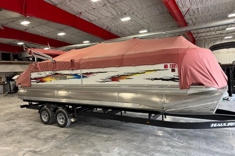 Slide: The Image of 2010 Manitou 25 X-Plode pontoon boat with cover in indoor storage. - 12