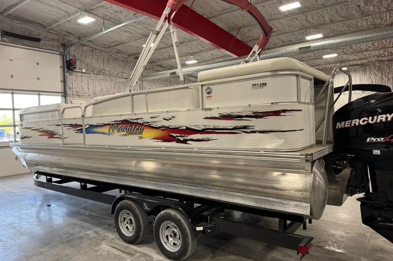 Slide: The Image of 2010 Manitou 25 X-Plode pontoon boat on trailer in indoor storage facility. - 3