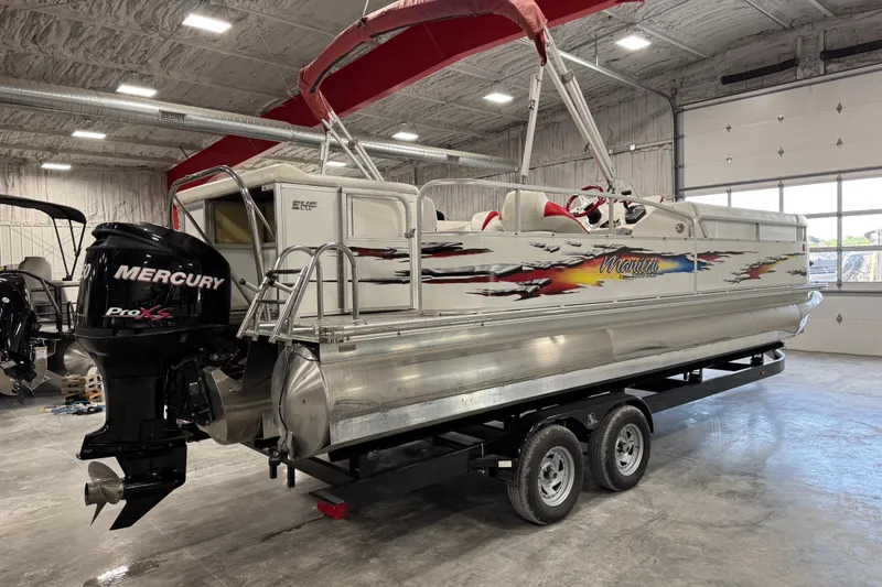Slide: The Image of 2010 Manitou 25 X-Plode pontoon boat with Mercury Pro XS engine in a garage. - 6