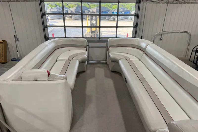 Slide: The Image of Interior of a 2010 Manitou 25 X-Plode pontoon boat with white seating. - 9