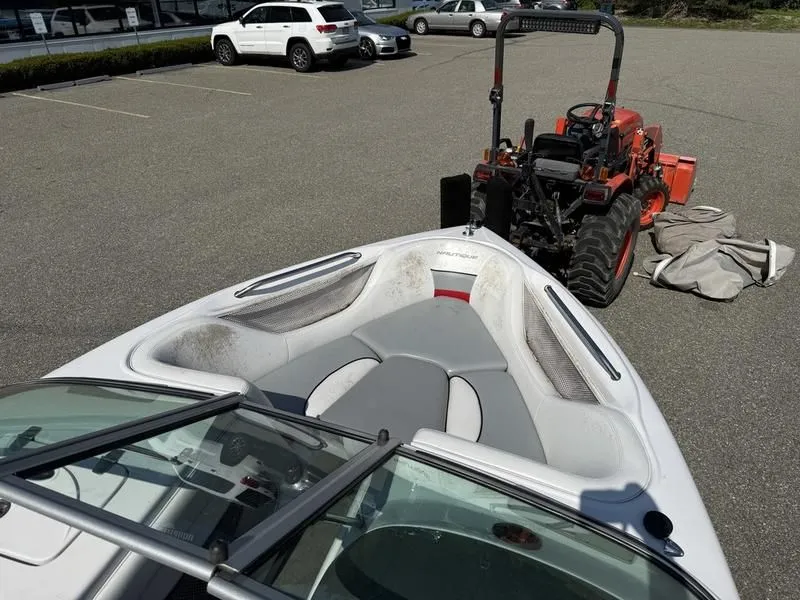 Slide: The Image of 2008 Nautique Ski Nautique 206 boat beside tractor in parking lot. - 22
