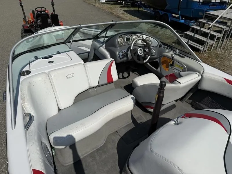 Slide: The Image of Interior of a 2008 Nautique Ski Nautique 206 boat with steering wheel and seats. - 23