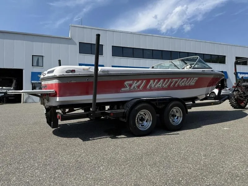 Slide: The Image of 2008 Nautique Ski Nautique 206 boat on trailer outside building. - 3