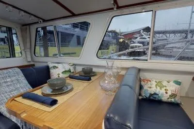 Slide: The Image of Interior of 2018 Ocean Sport 33 Roamer with dining area and scenic windows. - 11