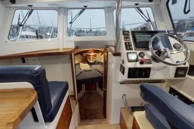 Slide: The Image of 2018 Ocean Sport 33 Roamer interior with helm, seating, and navigation equipment. - 6
