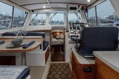 Slide: The Image of Interior of 2018 Ocean Sport 33 Roamer boat with helm, seating, and dining area. - 9