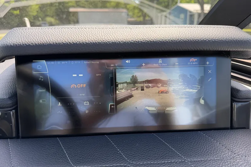 Slide: The Image of 2023 Nautique Super Air Nautique G25 dashboard display with navigation and control interface. - 10
