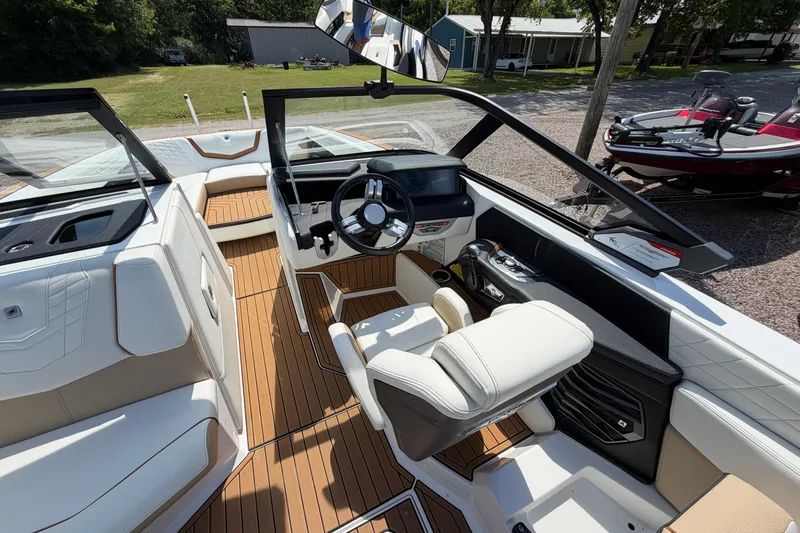Slide: The Image of 2023 Nautique Super Air Nautique G25 boat interior with modern dashboard and seating. - 14