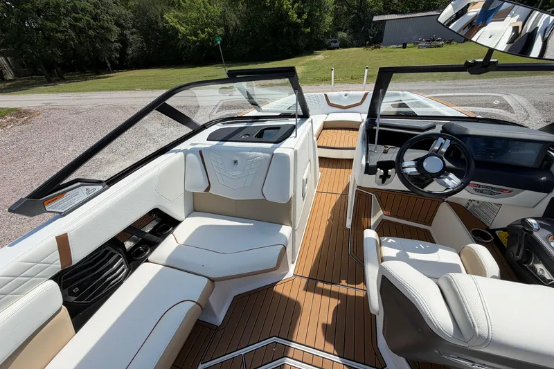 Slide: The Image of 2023 Nautique Super Air Nautique G25 interior with luxurious seating and modern dashboard. - 15