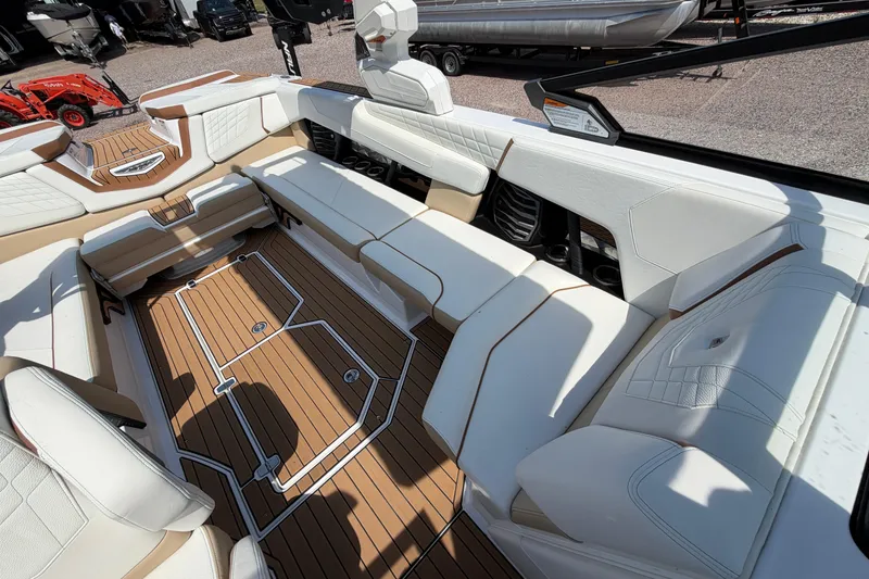 Slide: The Image of 2023 Nautique Super Air Nautique G25 interior with white seating and teak flooring. - 18
