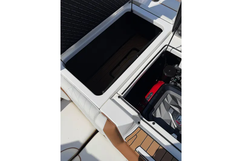 Slide: The Image of 2023 Nautique Super Air Nautique G25 engine compartment with open storage area. - 24