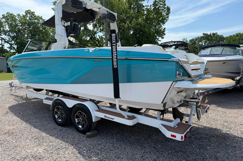 Slide: The Image of 2023 Nautique Super Air Nautique G25 boat on trailer, vibrant blue and white design. - 3