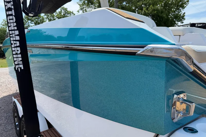 Slide: The Image of 2023 Nautique Super Air Nautique G25 boat with sleek blue and white design. - 4