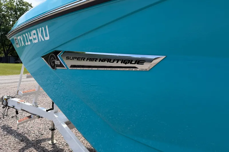 Slide: The Image of 2023 Nautique Super Air Nautique G25 boat in vibrant blue on trailer. - 6